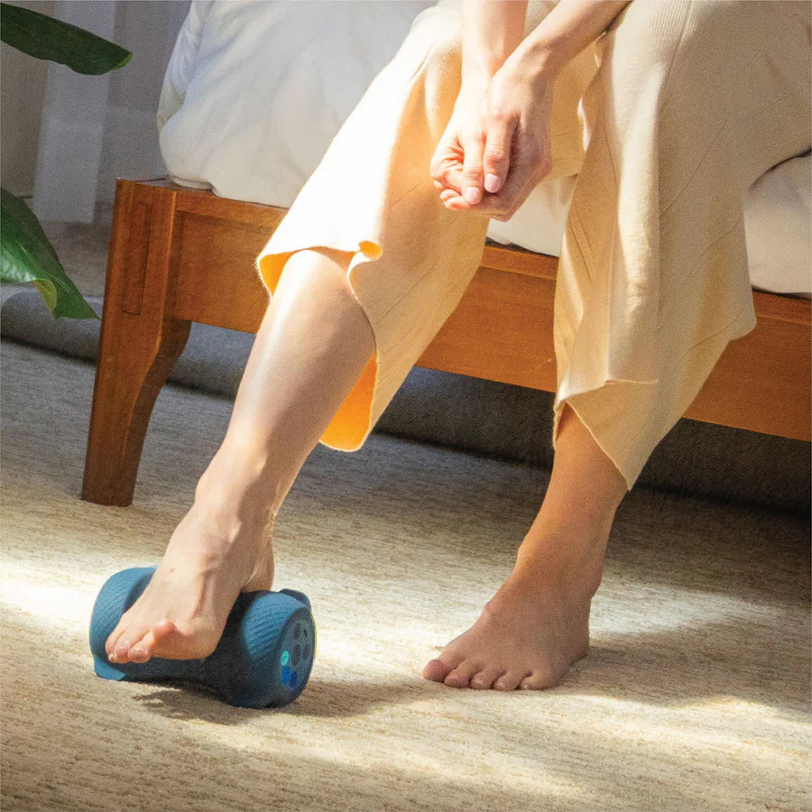 Person using Chirp Sole Vibe heated vibrating foot massager