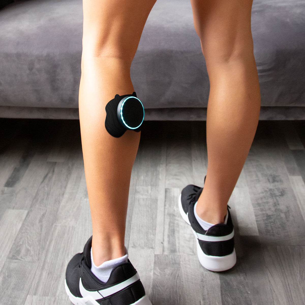 Person using Chirp Halo Calf Pad Set for targeted calf muscle stimulation and recovery