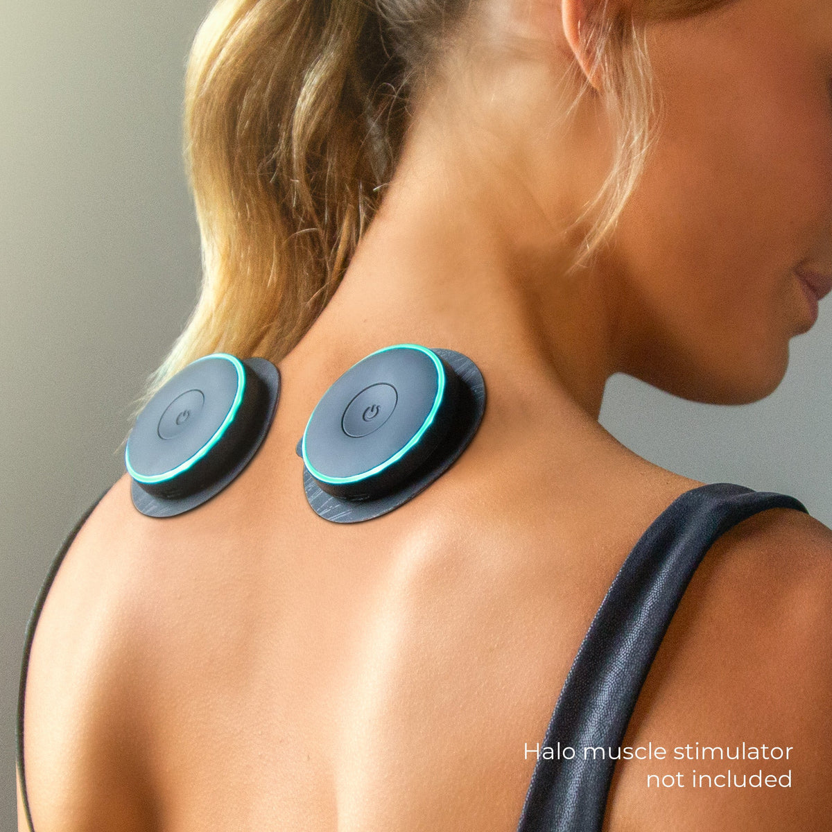 User wearing Chirp Halo Trigger Point Pad Set on neck and upper back muscles