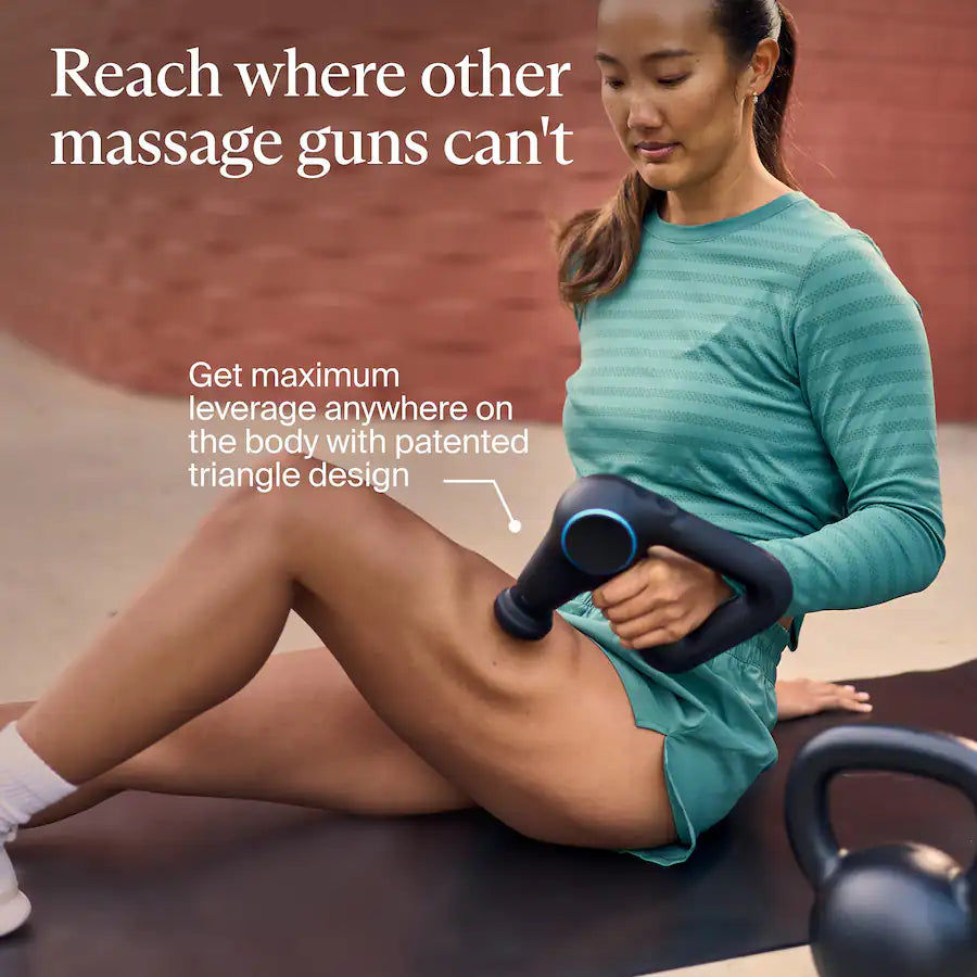 Woman using a massage gun on legs