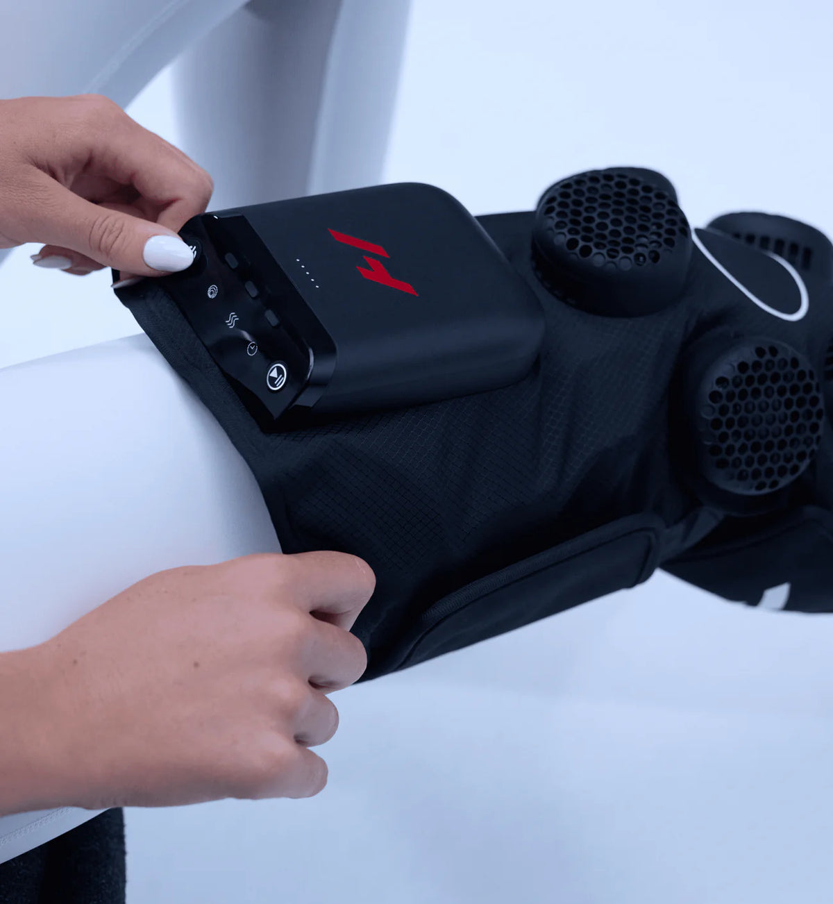 Person using a Hyperice X 2 Knee heat and cold therapy device