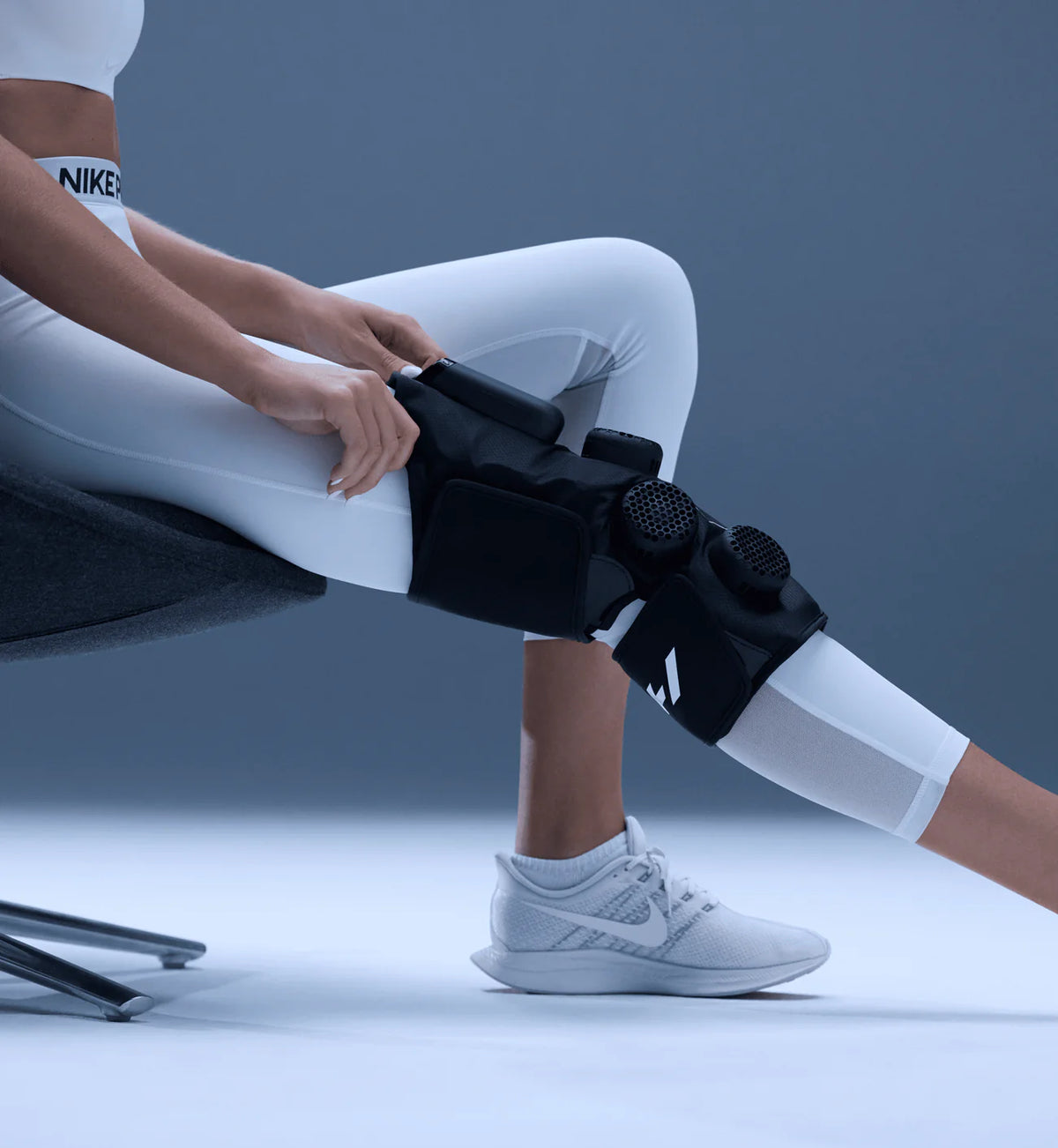 Person using a Hyperice X 2 Knee electronic therapy device for targeted knee recovery