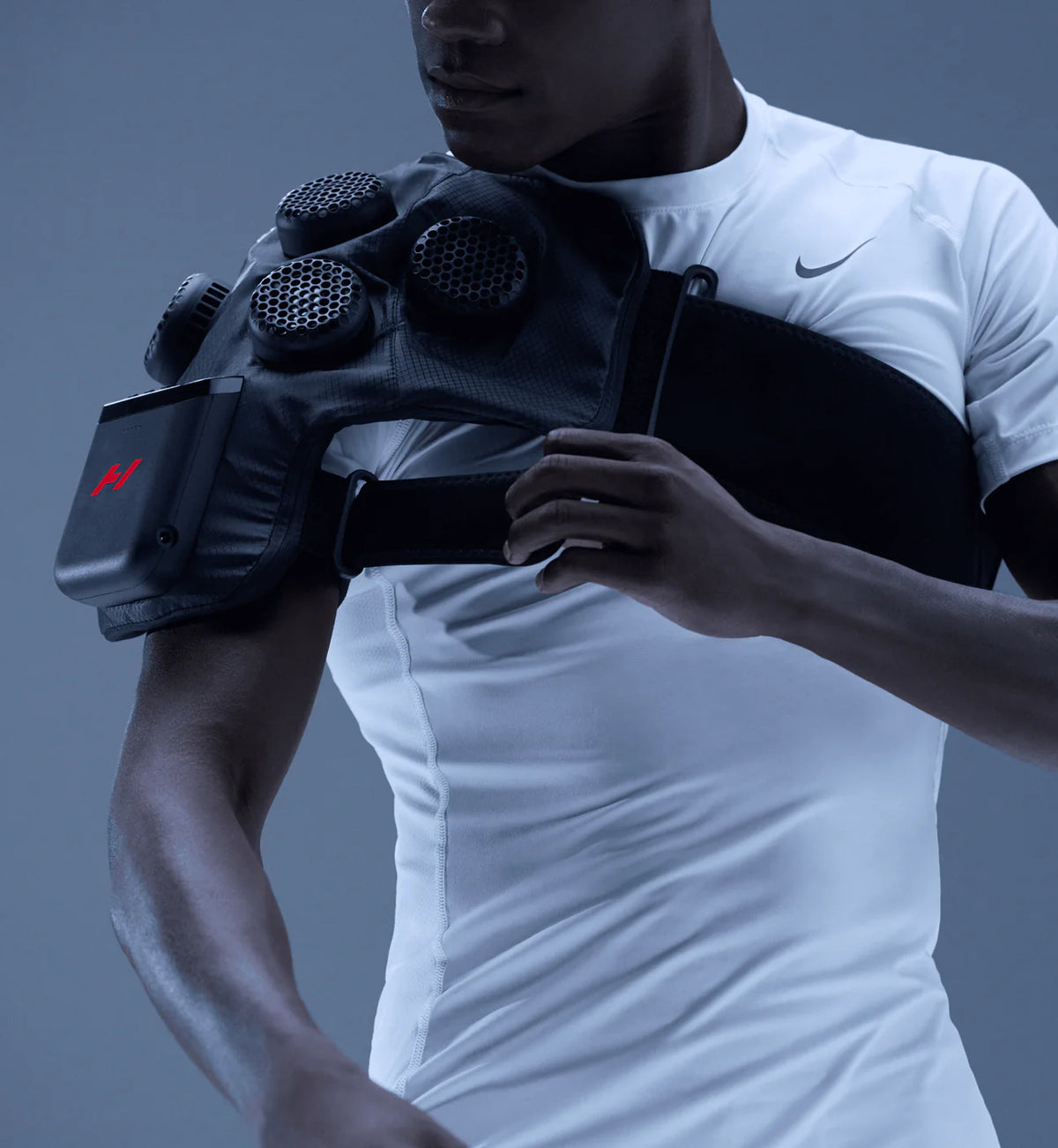 Athlete adjusting Hyperice X 2 Shoulder therapy device