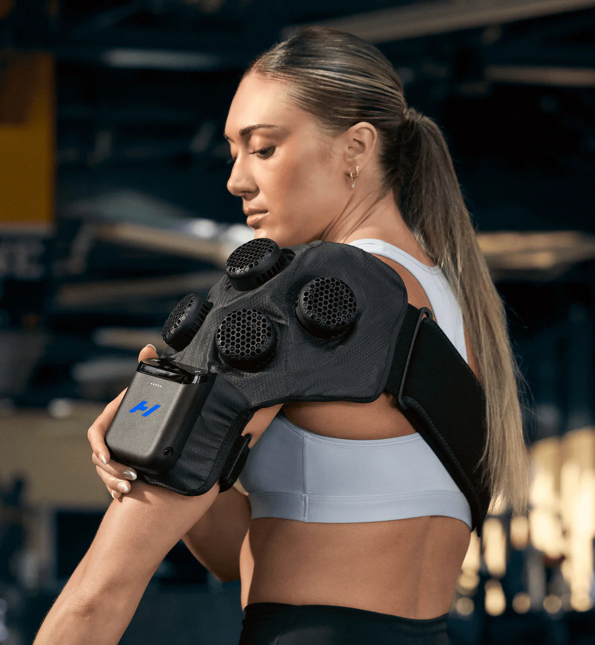 Woman wearing Hyperice X 2 Shoulder recovery device