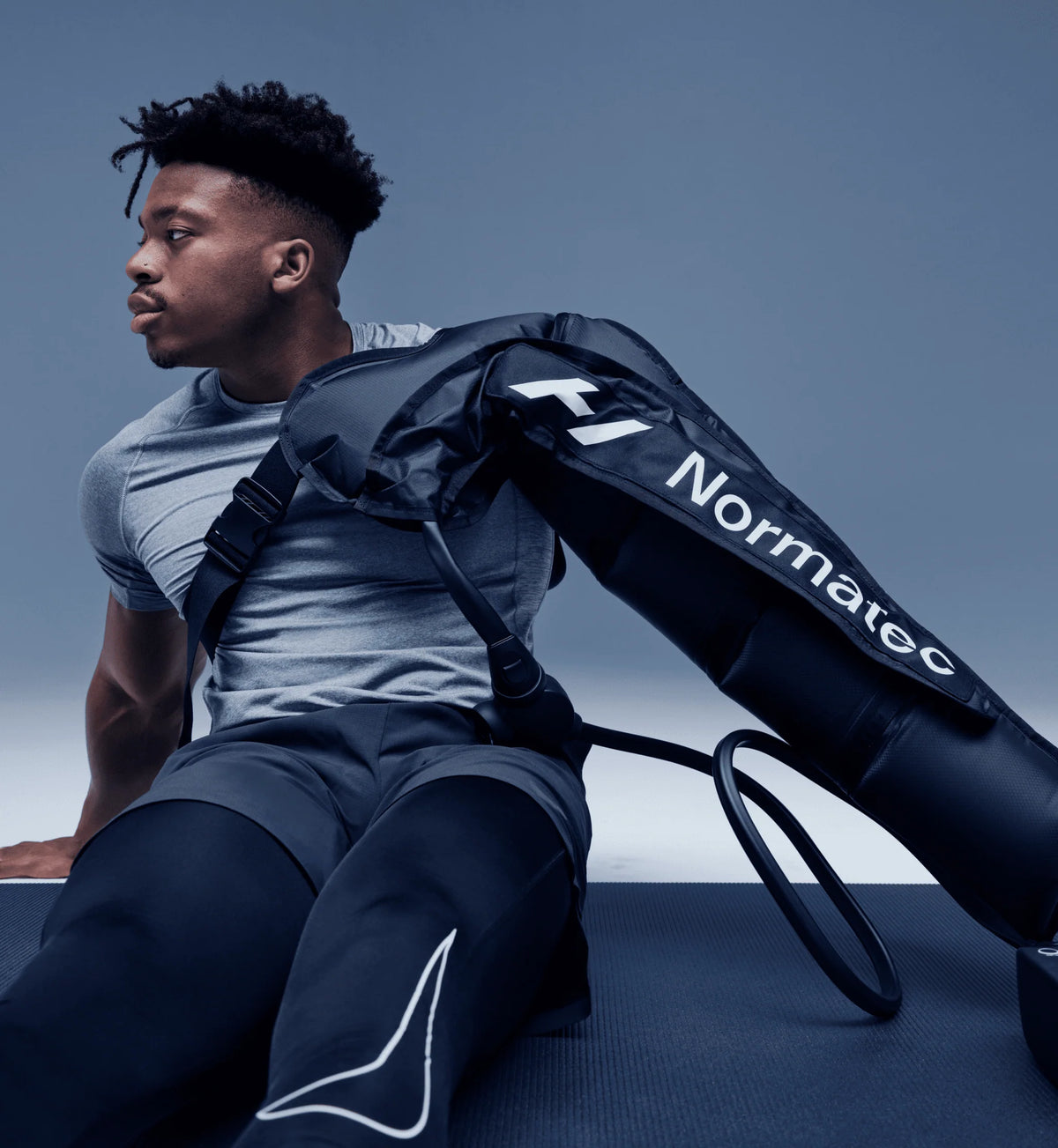 Man using Hyperice Normatec 3 leg compression system