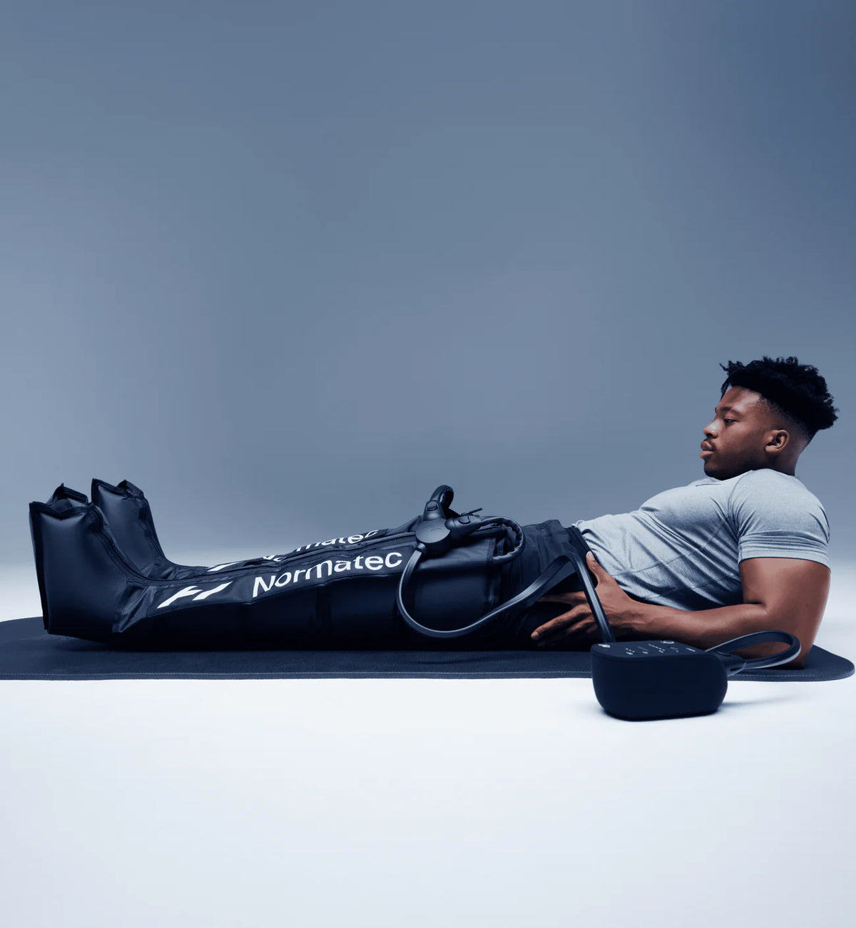 Person using a Hyperice Normatec 3 compression system