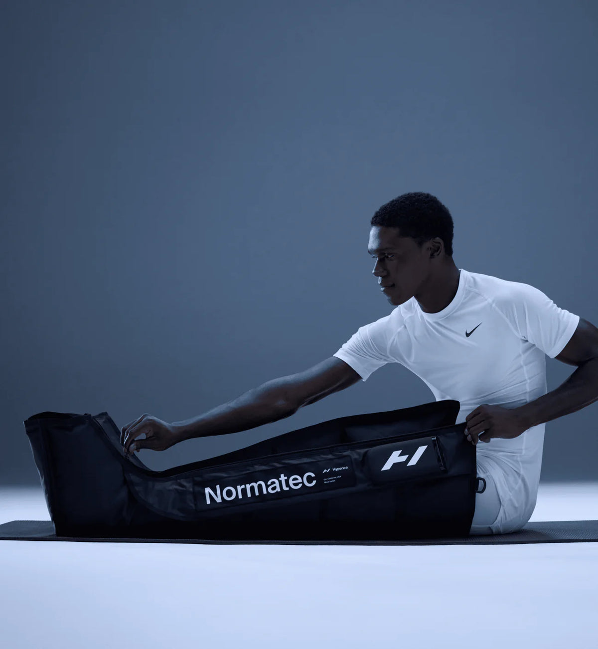 Man using Hyperice Normatec Elite Legs compression recovery system