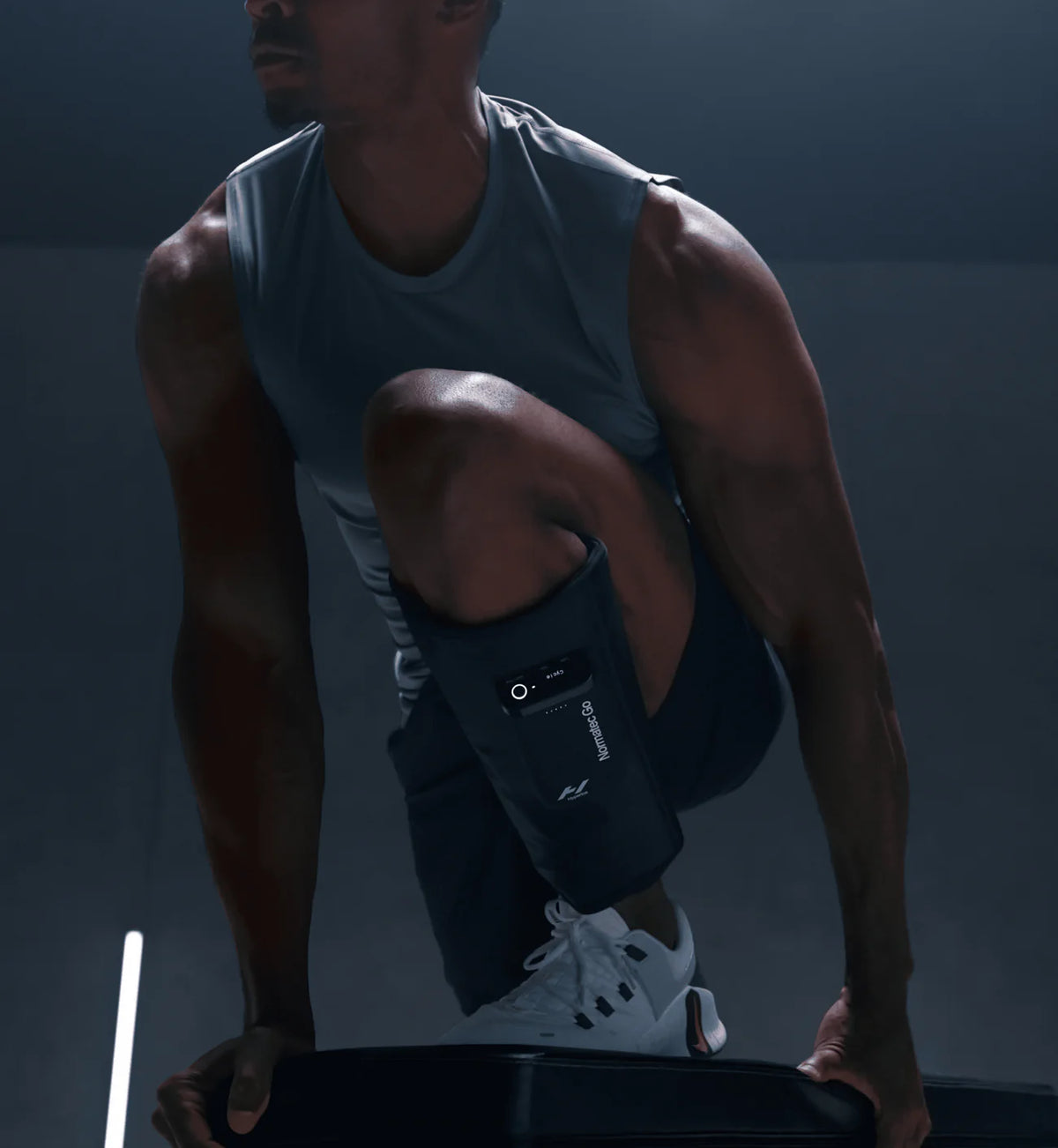 Person wearing Hyperice Normatec Go sleeves