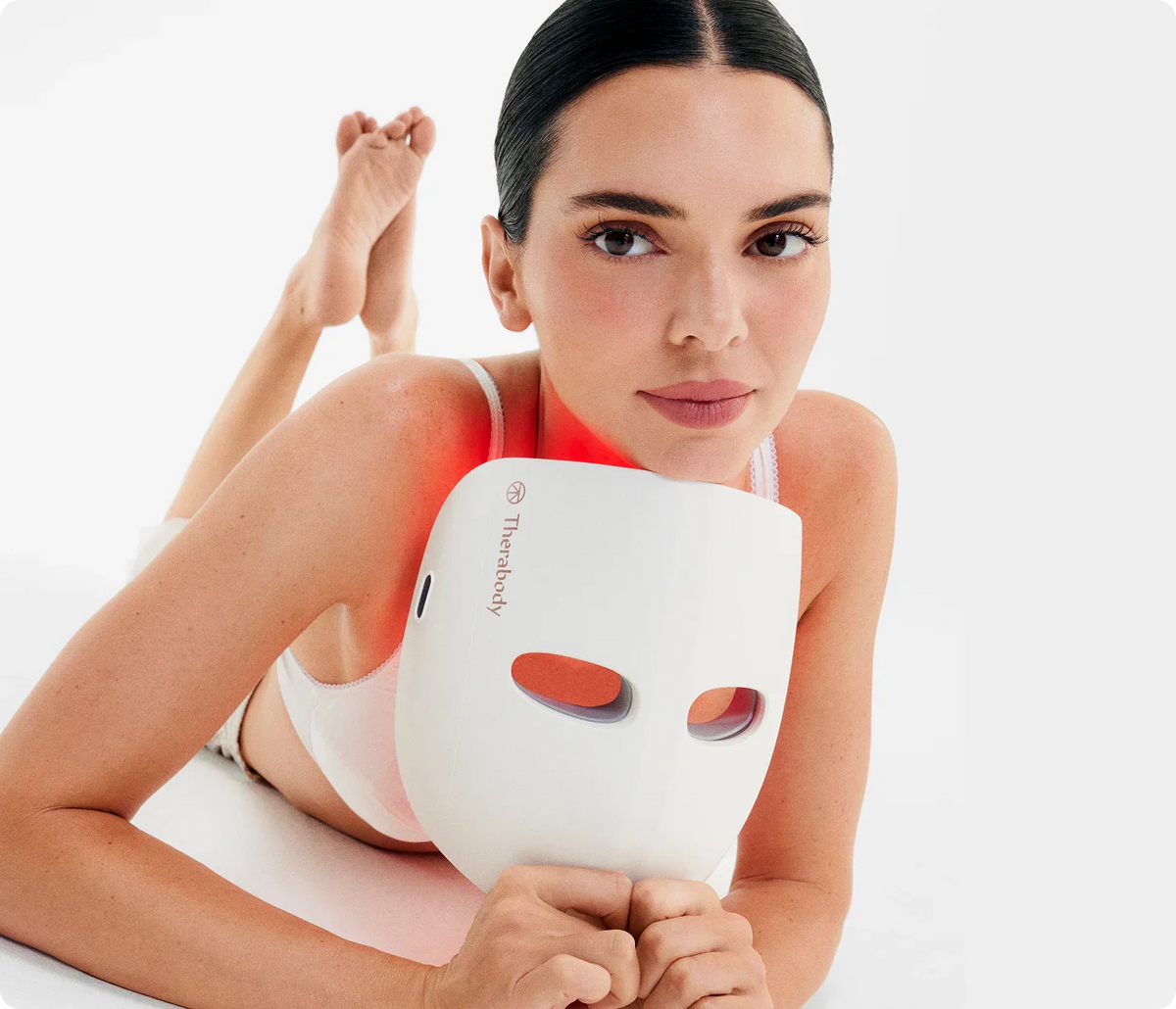 Women with Therabody TheraFace LED Mask for at-home skincare routine