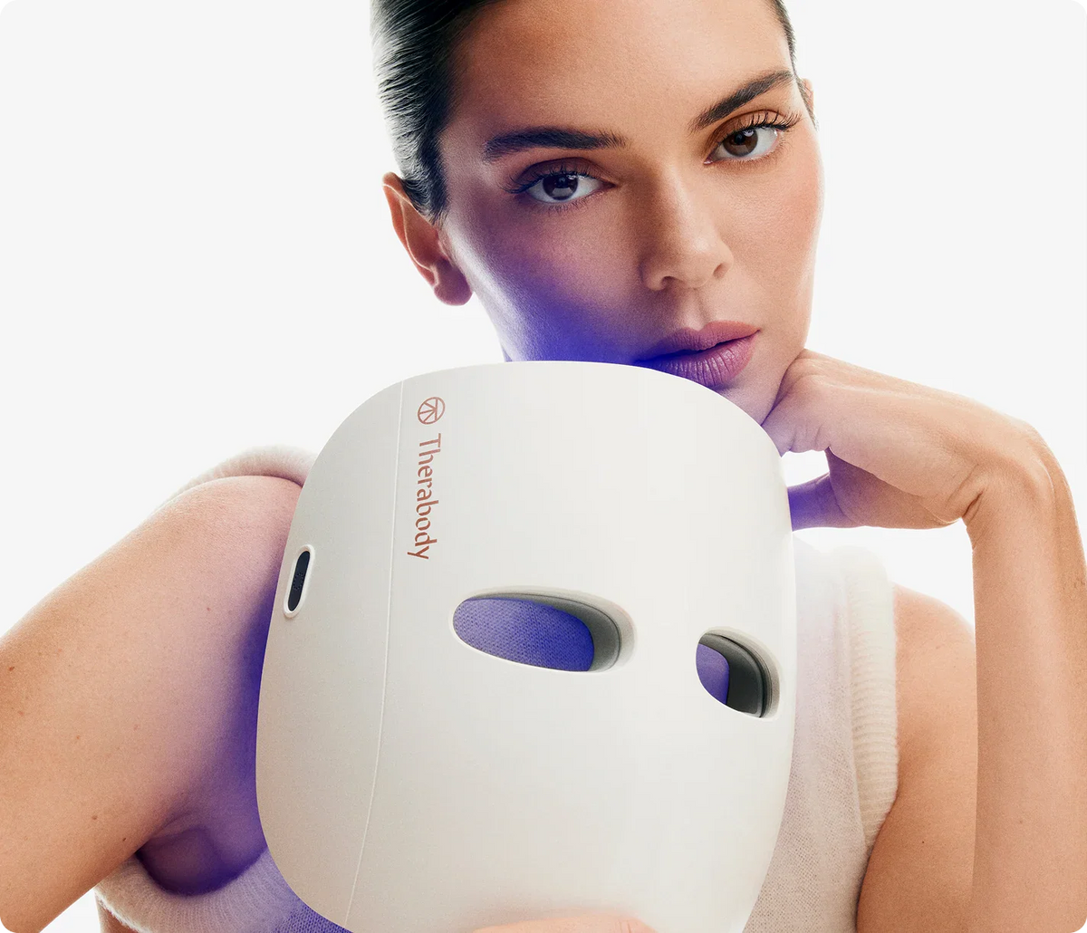 Women holding Therabody TheraFace LED Mask
