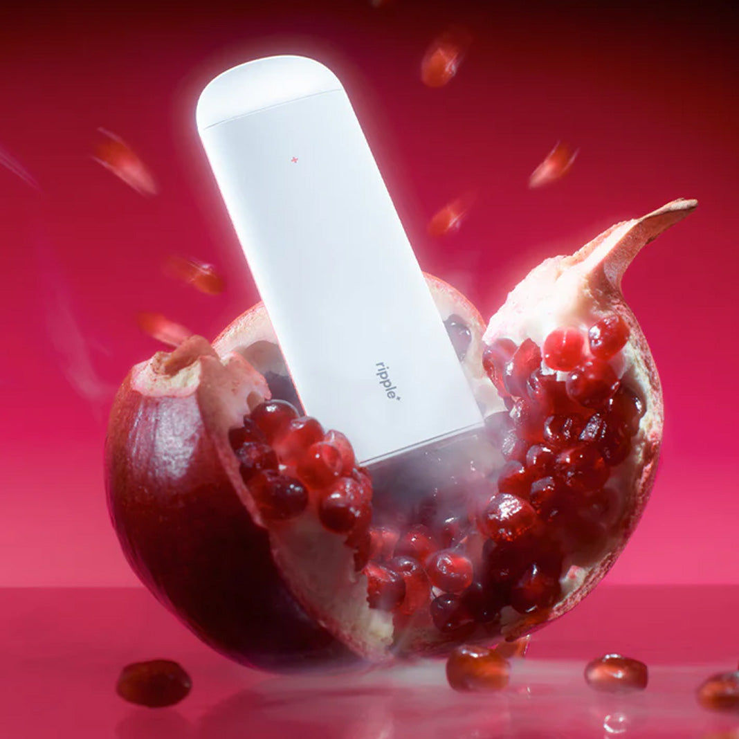pomegranate flavored vape device fruit splash background