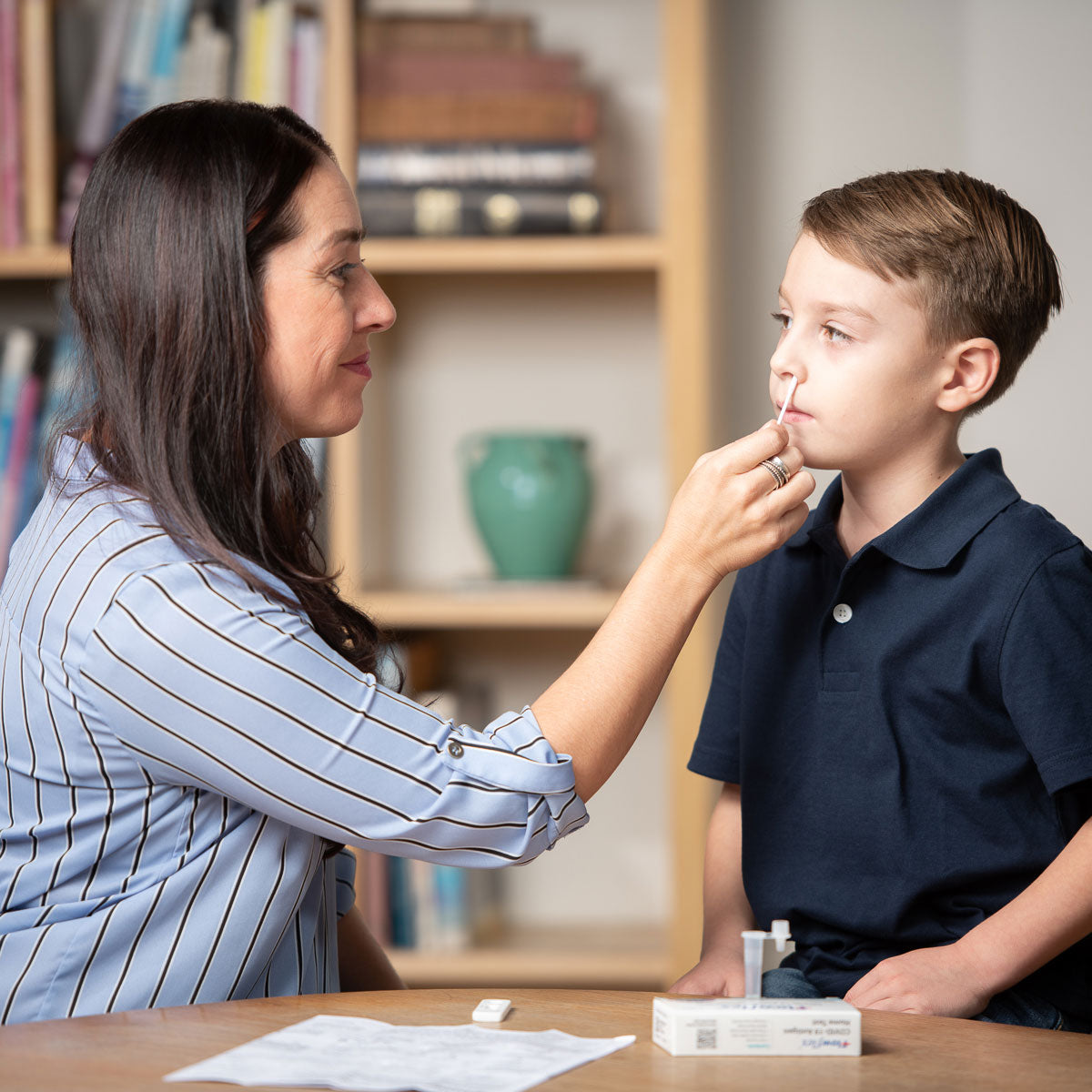 Parent administering Flowflex Plus COVID-19 and flu test to child at home