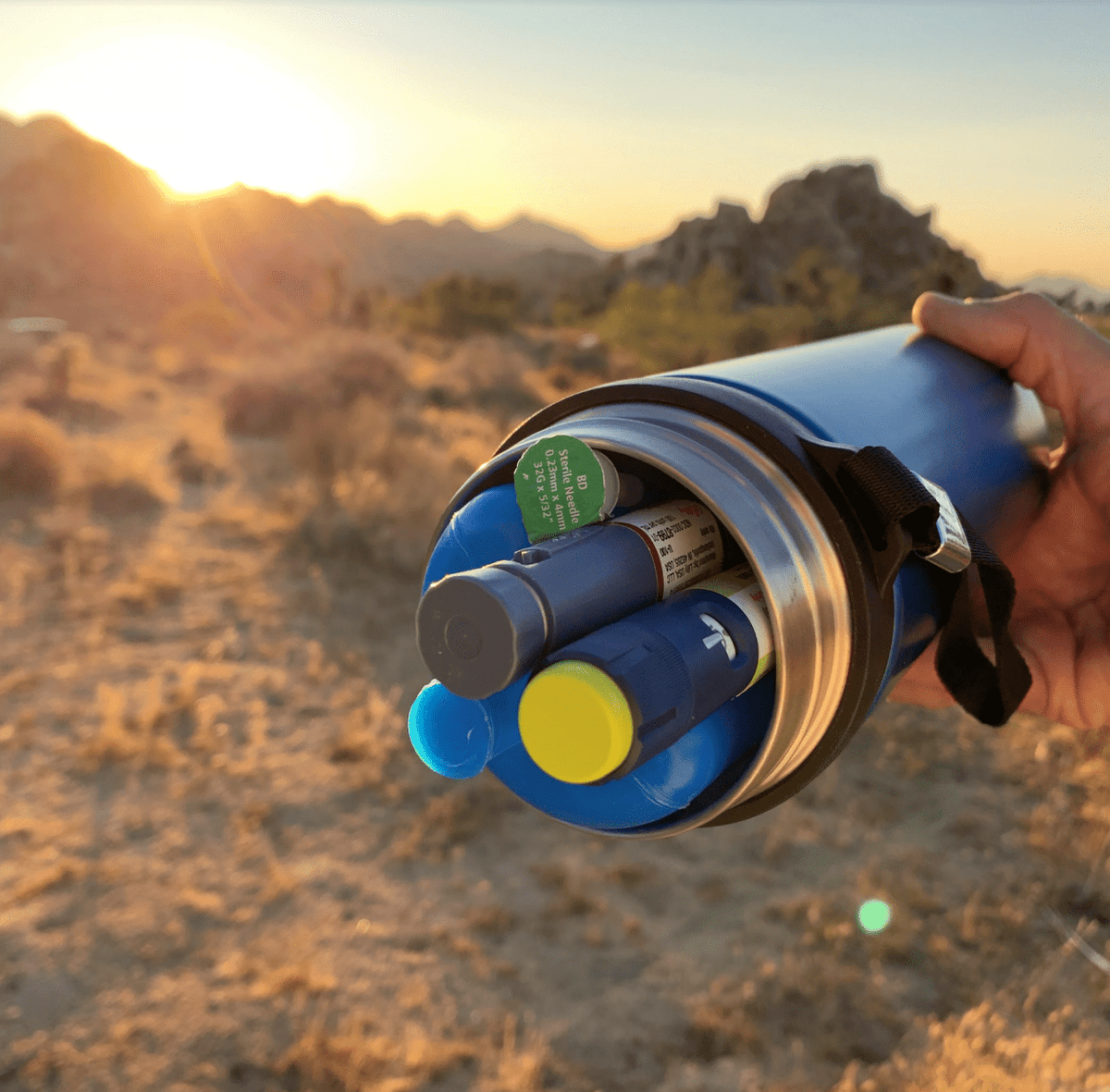 Person using 4ALLFAMILY portable insulin travel cooler outdoors during travel