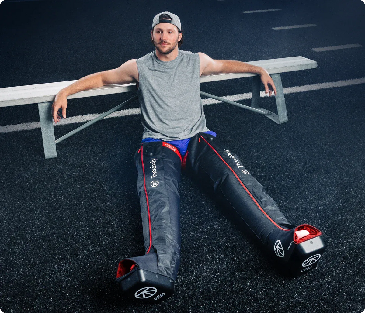 Athlete wearing Therabody JetBoots PRO Plus for wireless leg compression and recovery