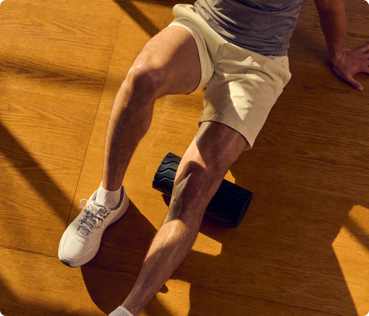 Athlete using a Therabody foam roller for post-workout muscle recovery