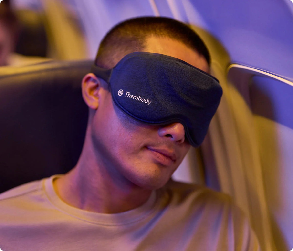 Men wearing Therabody SleepMask for relaxation during travel