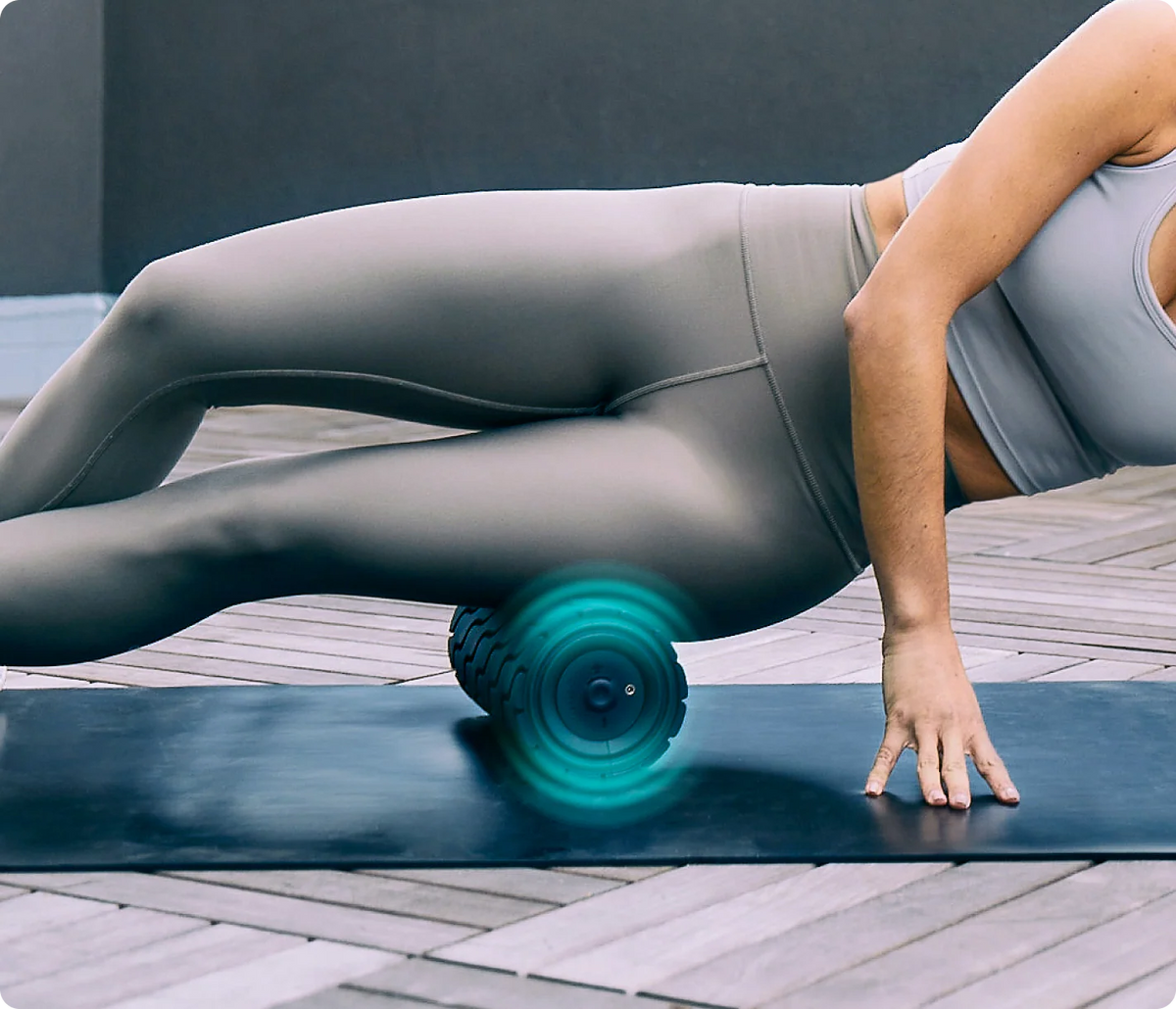 Woman using a Therabody foam roller to relieve muscle tension and improve mobility