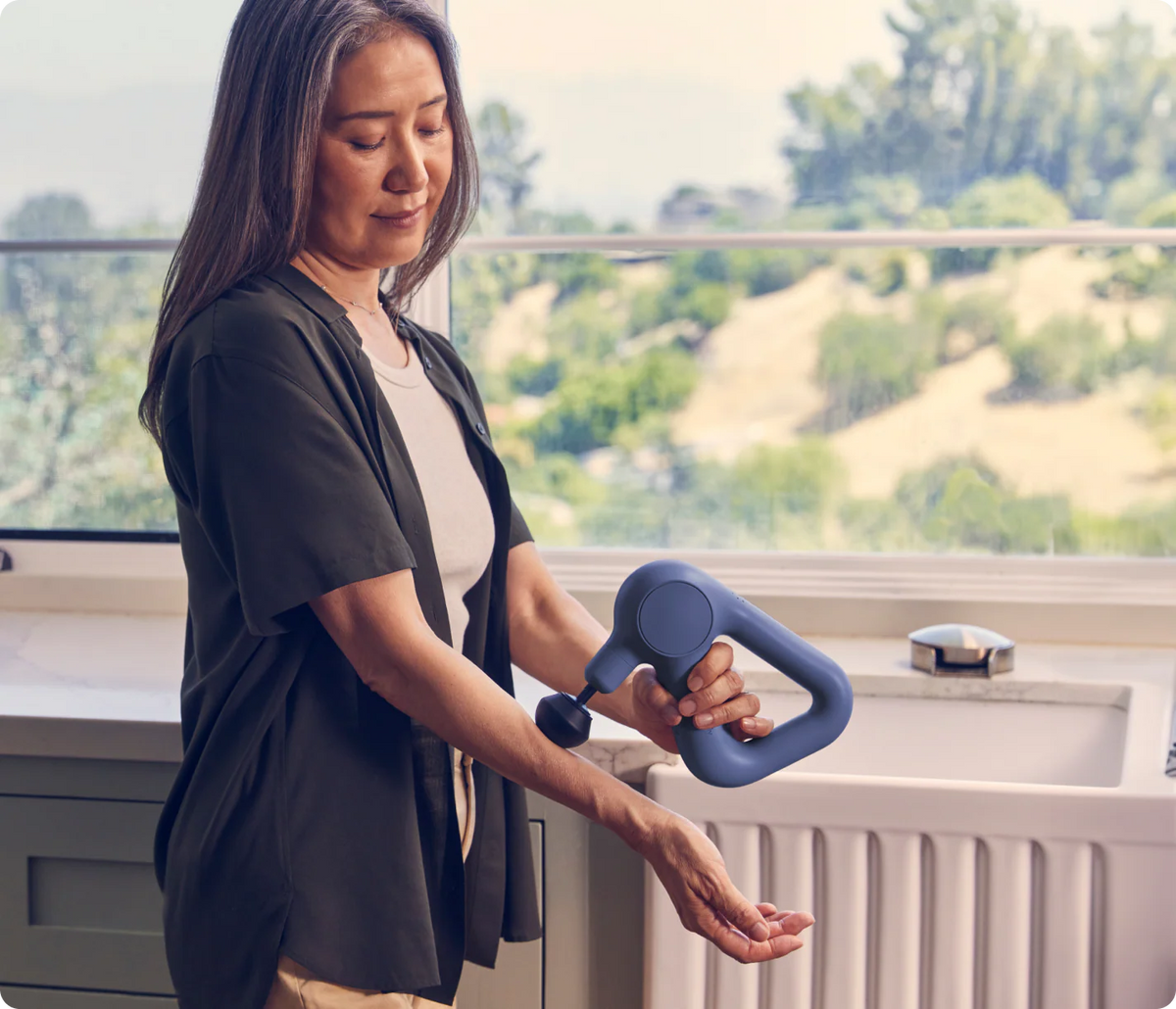 Women using Therabody Theragun Relief on wrist and forearm muscles