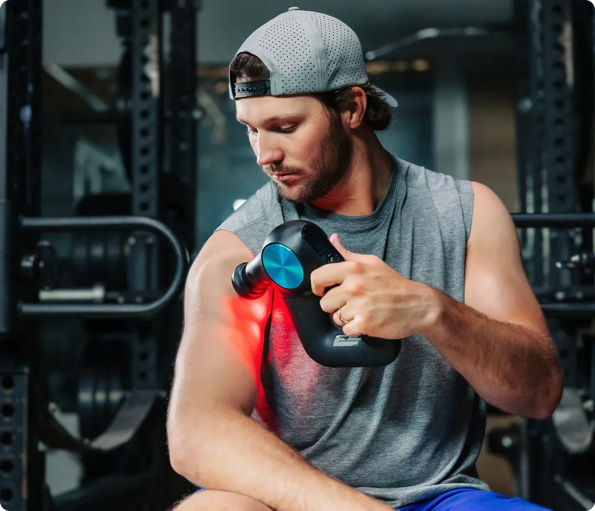 Man using Therabody Theragun Pro Plus on shoulder muscles after workout