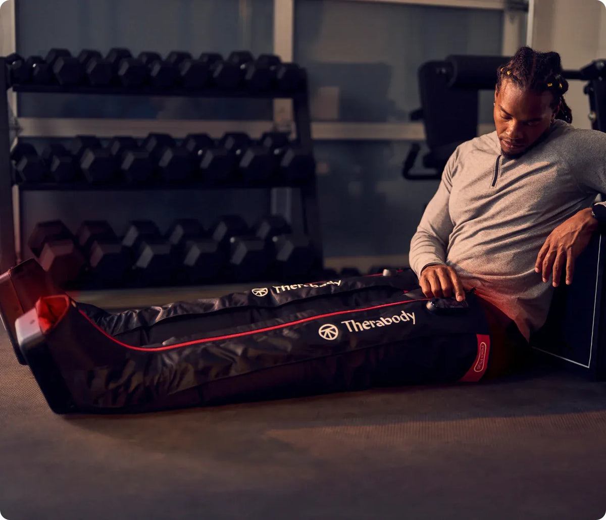 Athlete using Therabody JetBoots PRO Plus Wireless Leg Compression boots for recovery