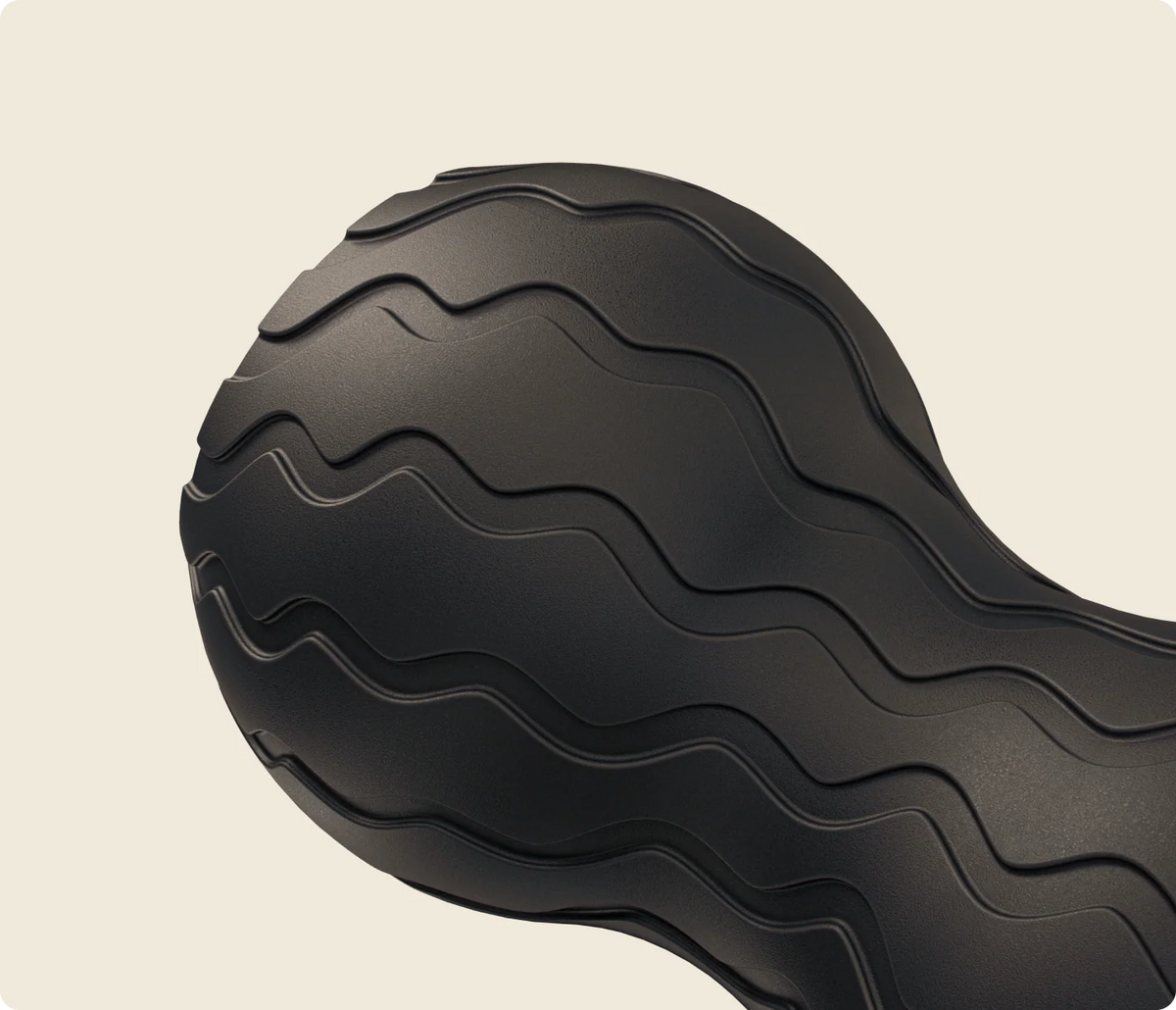 Close-up of Therabody WaveDuo vibrating muscle roller with textured massage surface