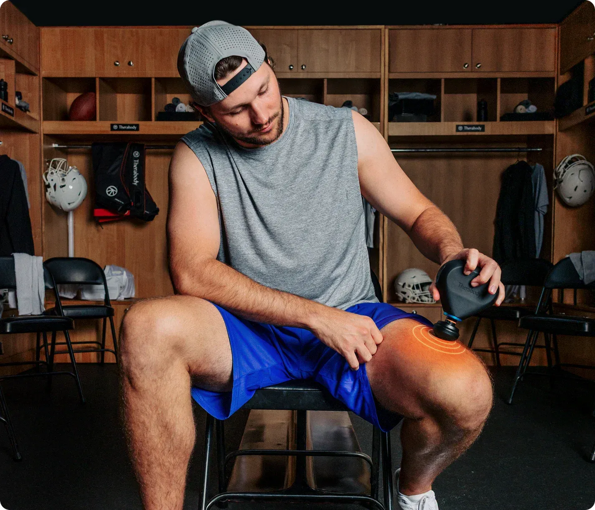 Man using Therabody Theragun Mini on thigh muscles after workout