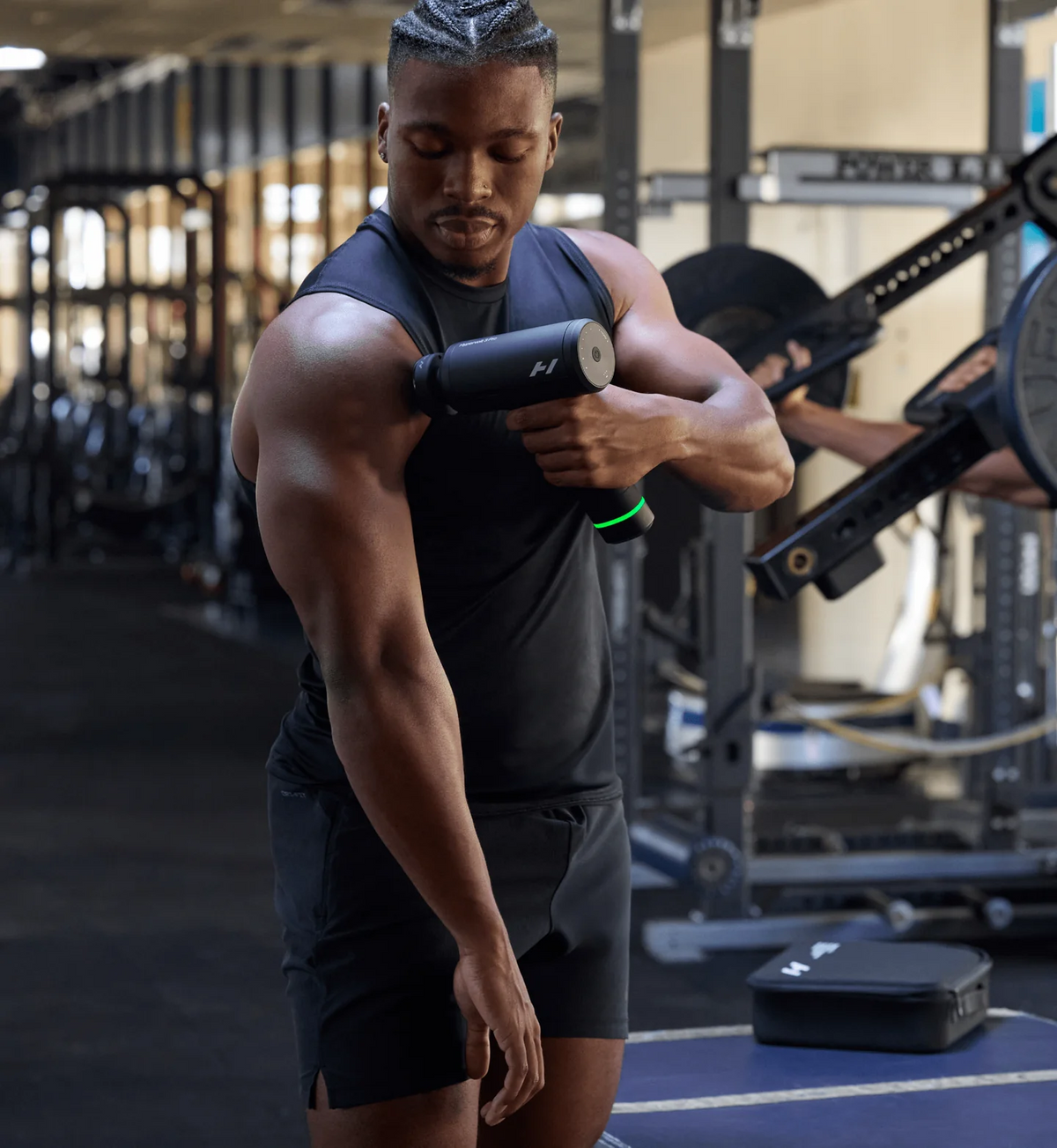 Man using Hyperice Hypervolt 3 Pro percussion massage gun