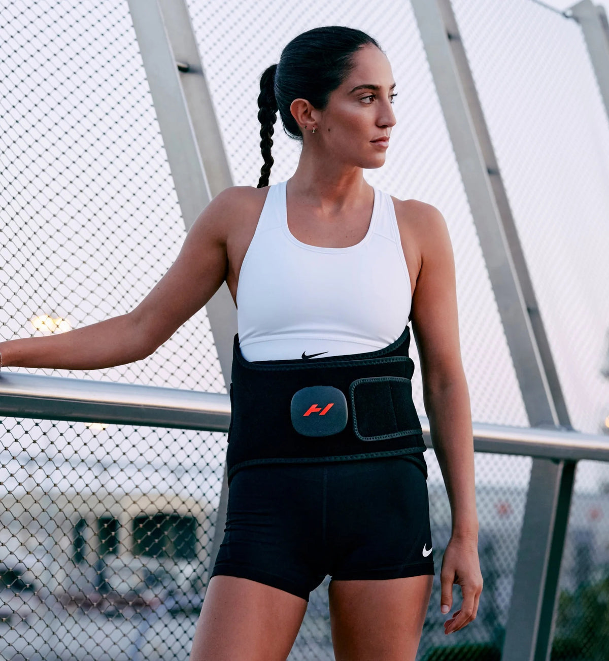 Woman wearing Hyperice Venom 2 Back Heated Massage Wrap during activity
