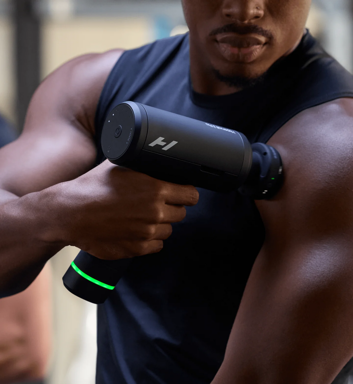 Person using Hyperice Hypervolt 3 Pro percussion massage gun on their arm